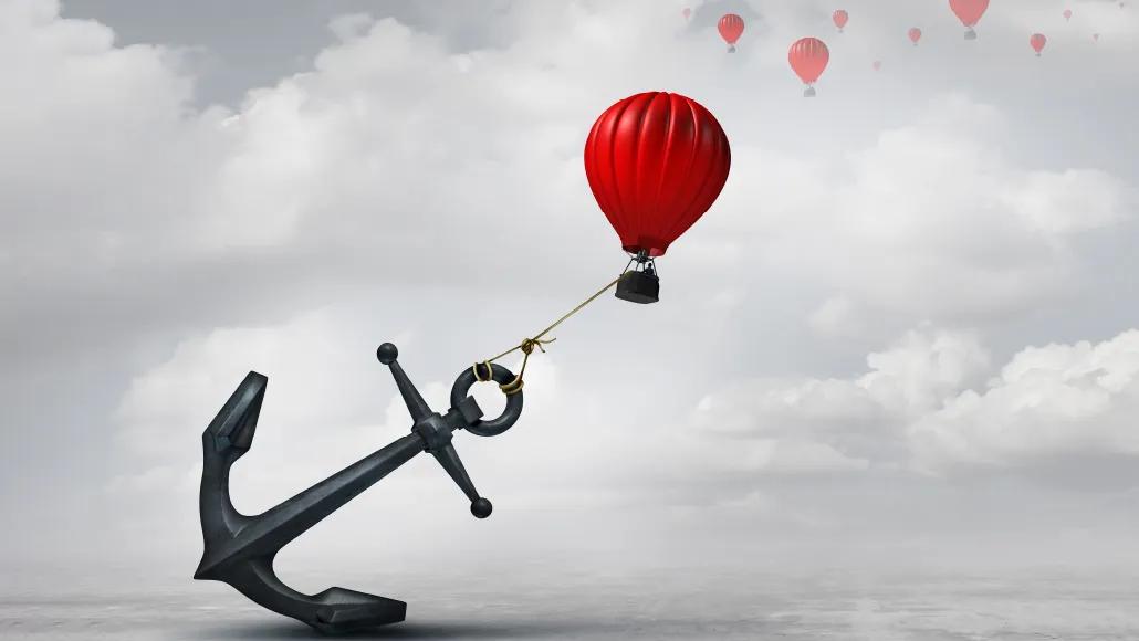 An illustration shows a hot air balloon constrained by a huge anchor.