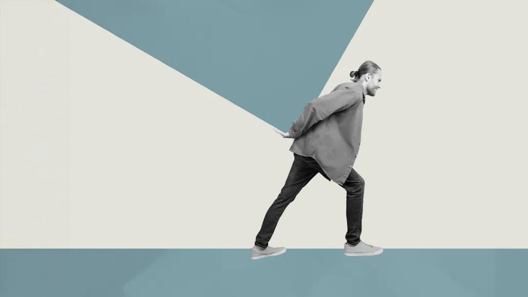 An illustration shows a person struggling to hold something heavy on their back.