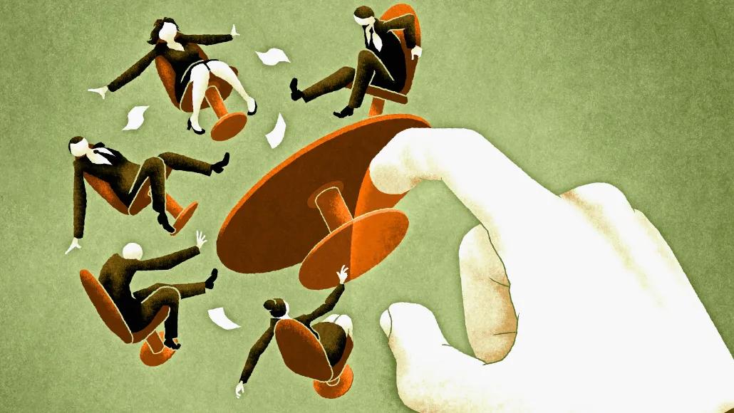 An illustration shows a large hand overturning a table and the employees seated around it.