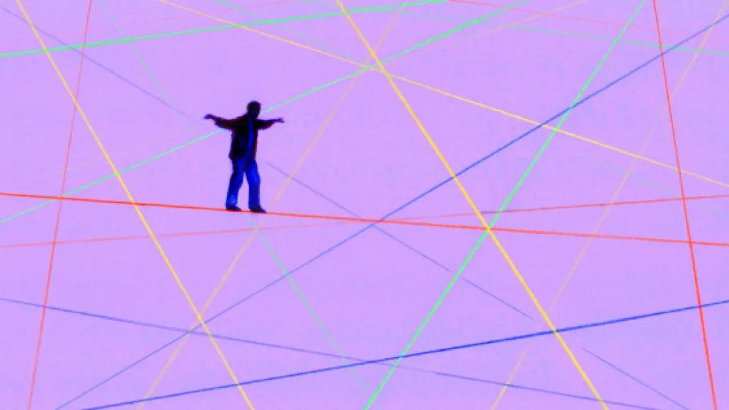 An illustration depicts a man walking across a red wire amongst other wires and a purple background