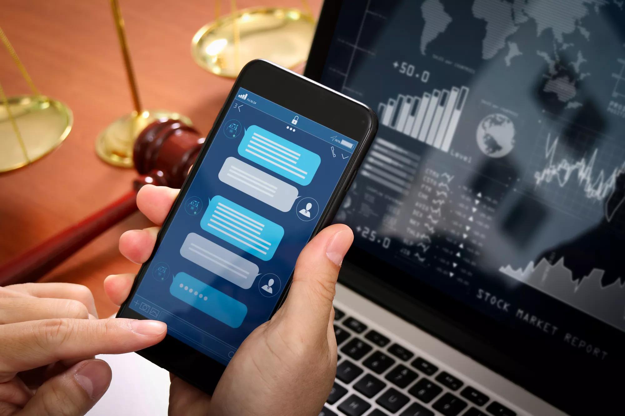 Chatbot conversation with smartphone screen app interface and artificial intelligence technology processing virtual assistant with customer support information,Lawyer hand holding mobile phone.