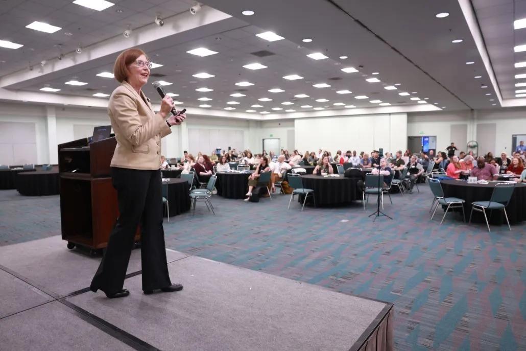 A photo shows ALC keynote presenter Tina Robinson on stage.