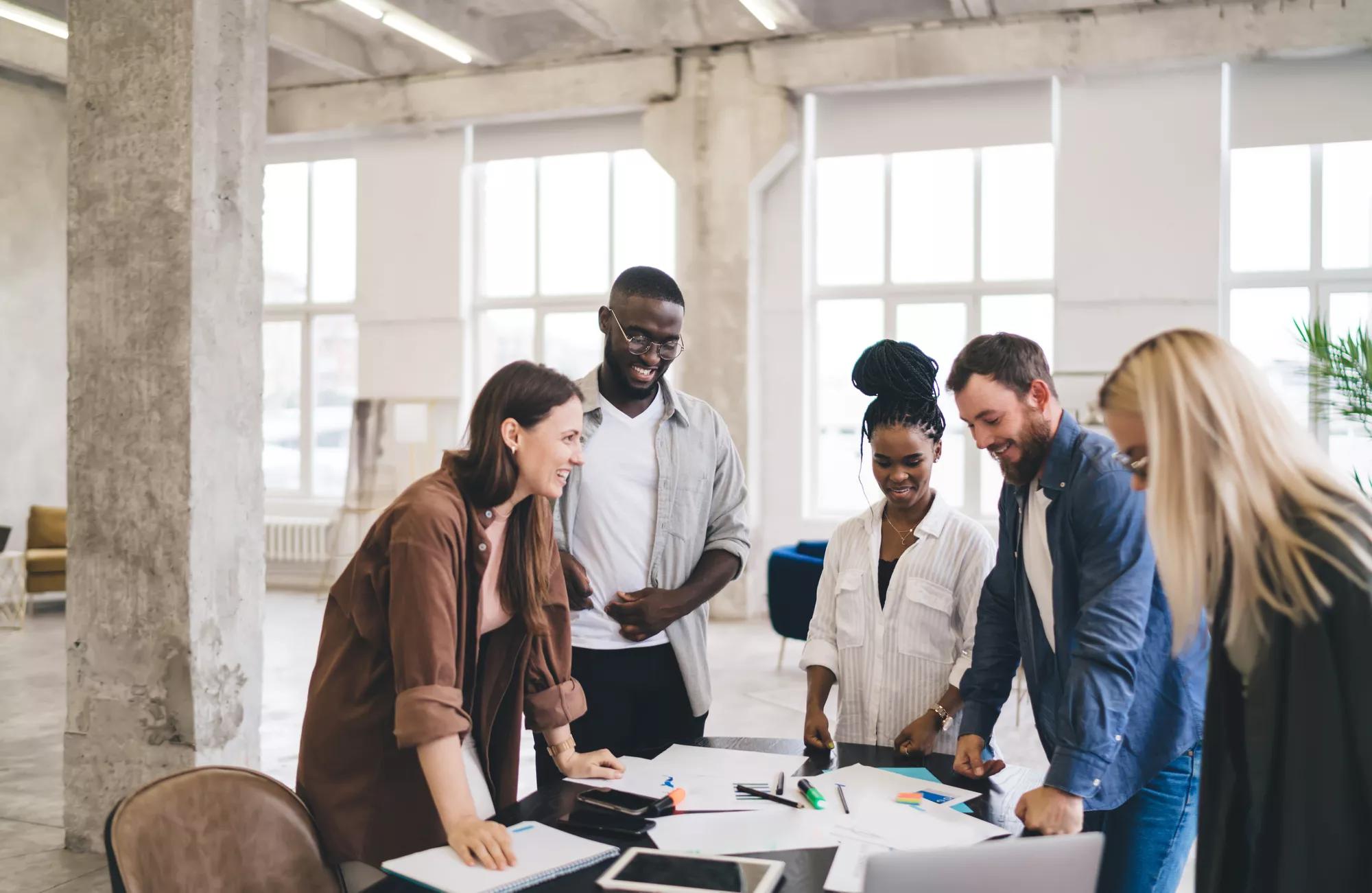 Creative group of designers coworking in loft office