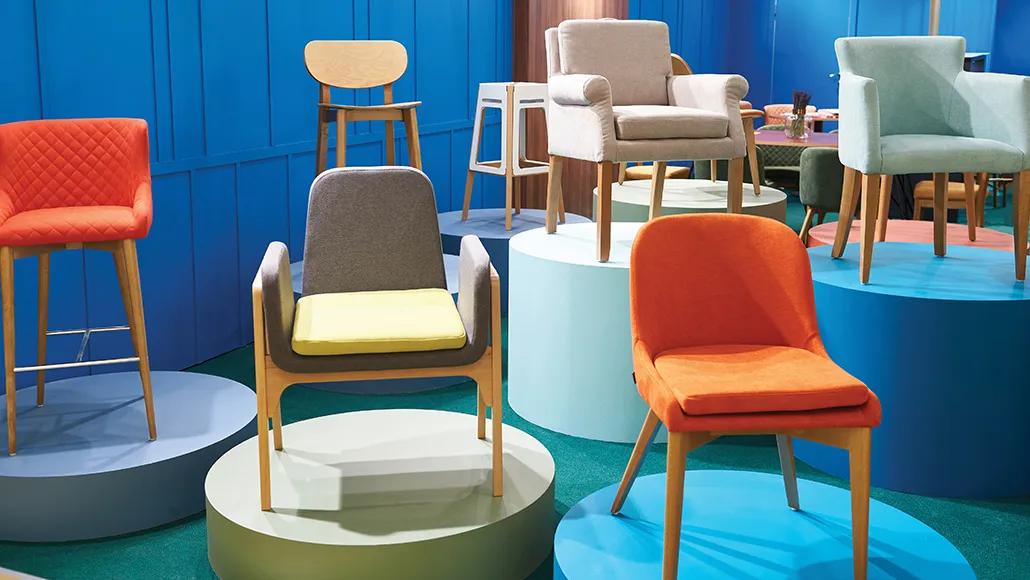 A room full of chairs and stools on pedestals.