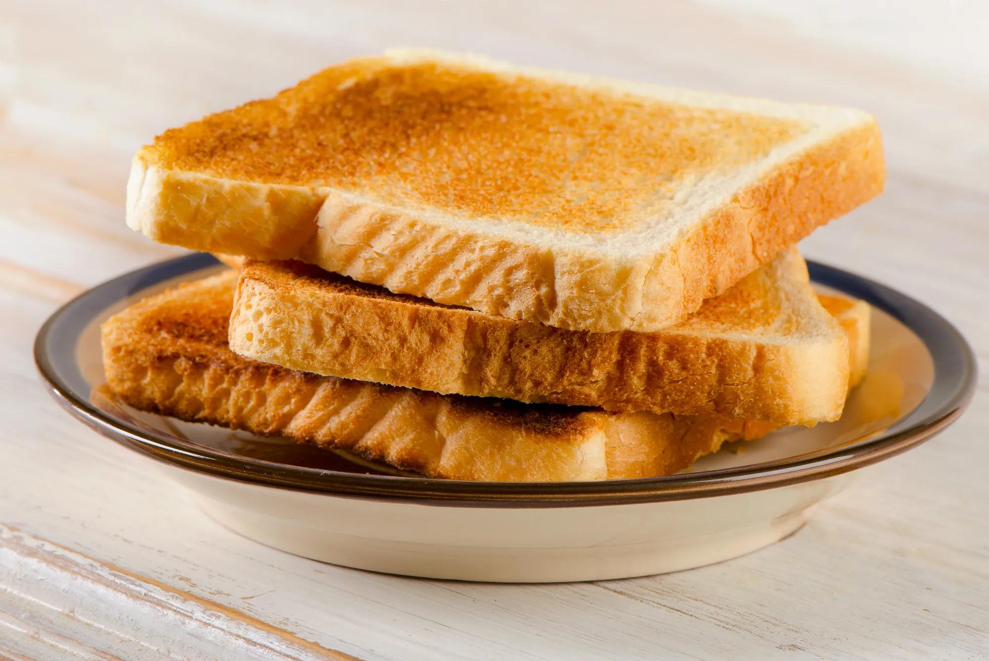 Slices toast bread on a  wooden table