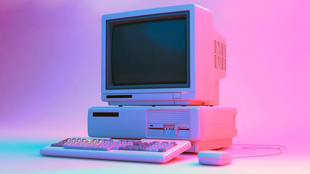 An old, 1990s computer setup with a hard drive, floppy disk drive, wired mouse, and keyboard.