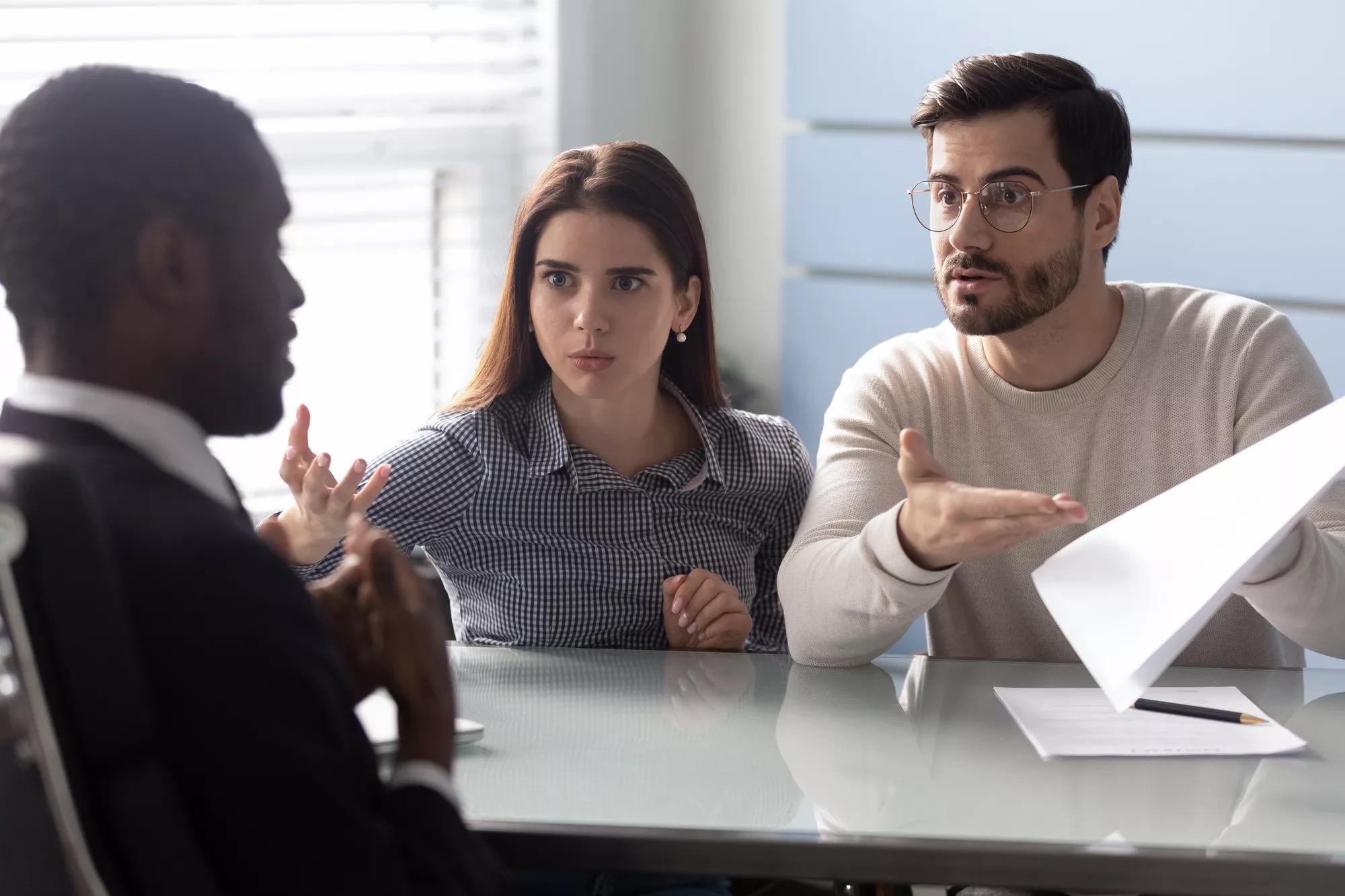 Angry clients couple argue with agent for paperwork contract mistake