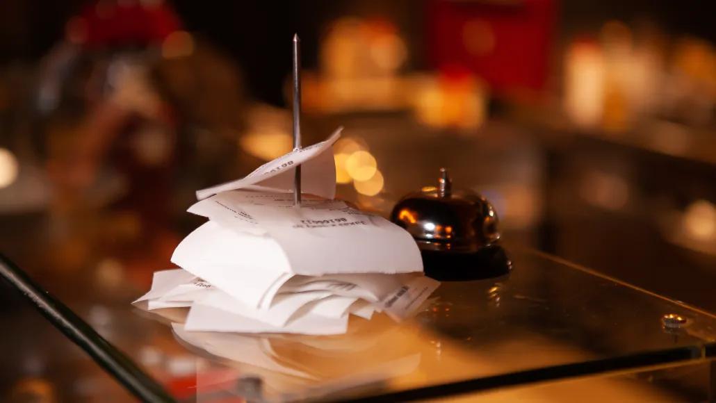 A photo shows restaurant orders on a bar