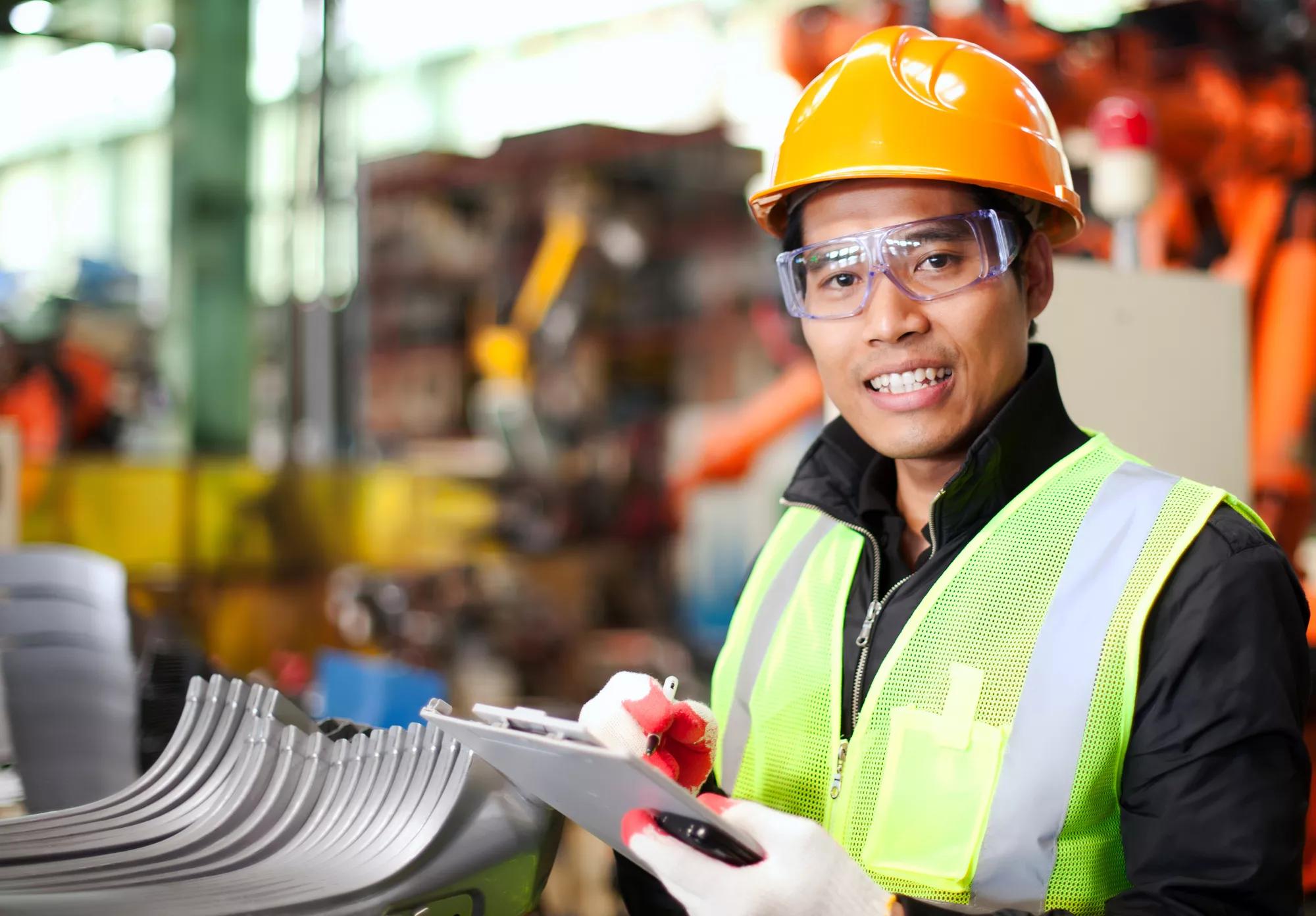 Portrait of young engineer taking notes