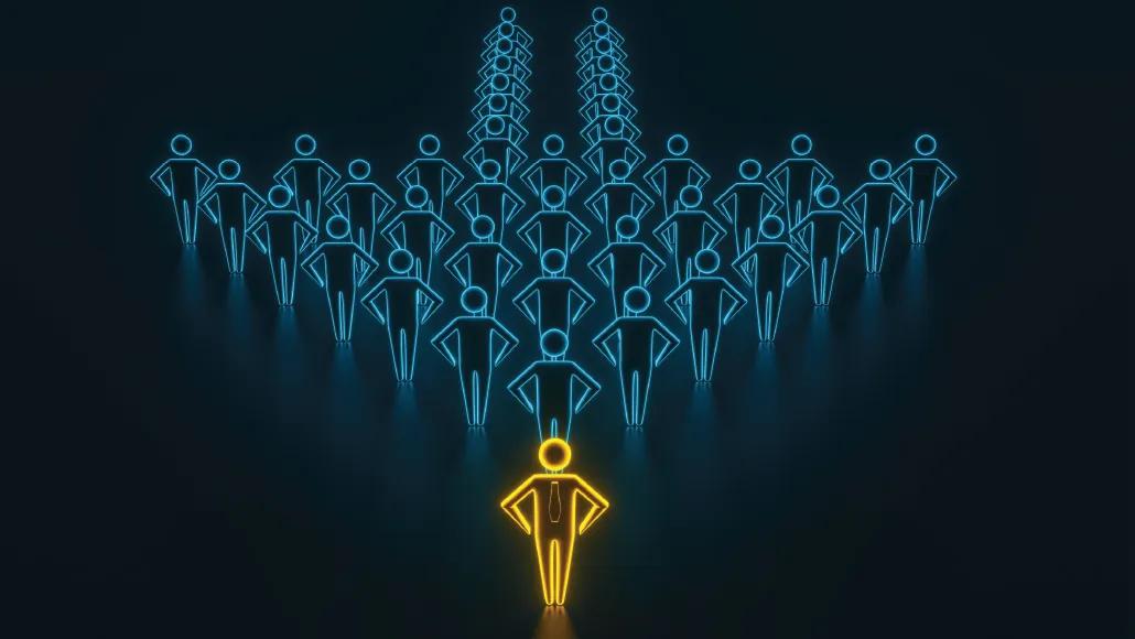 An illustration depicts a group of people positioned in the shape of an arrow with the person at the front in a different color.